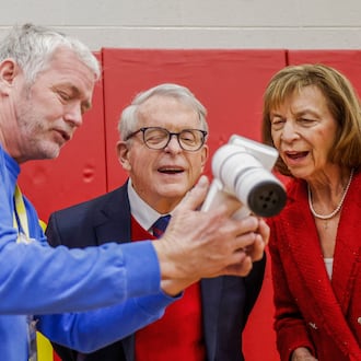 Don Engel, left, optical technician for Health Partners of Western Ohio, shows Ohio Gov. Mike DeWine, center, and First Lady Fran DeWine technology he uses to examine student's eyes as part of a new children's eyesight program, OhioSEE, at Northeastern Elementary School on Monday, Feb. 9, 2026, in South Vienna. JOSEPH COOKE/STAFF