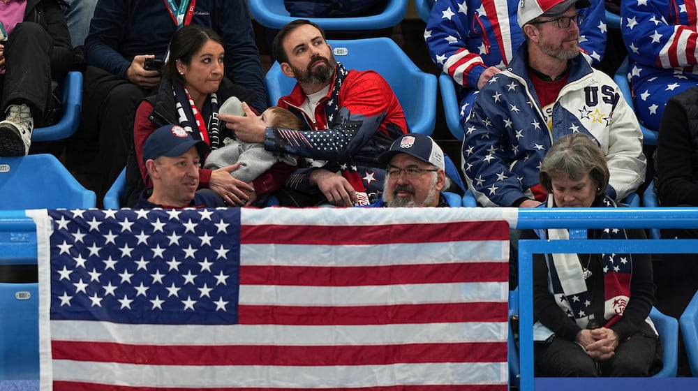 US supporters watch during the gold medal mixed doubles curling match between USA and Sweden, at the 2026 Winter Olympics, in Cortina D'Ampezzo, Italy, Tuesday, Feb. 10, 2026. (AP Photo/Fatima Shbair)