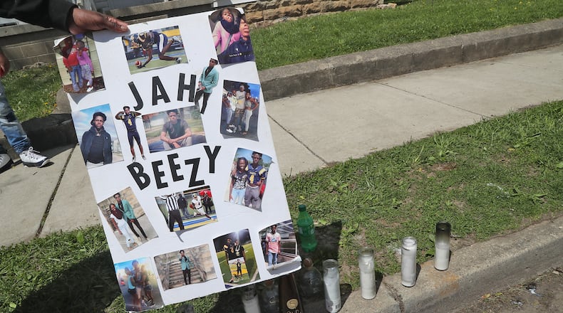 A memorial has started to form at the scene of a fatal mass shooting along Clifton Avenue Monday, May 2, 2022. One woman was killed and four others wounded in a shooting in front of 1227 Clifton Avenue early Sunday morning. BILL LACKEY/STAFF