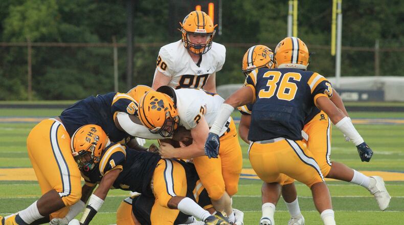 Springfield defenders tackle Marty Lenehan, of Saint Ignatius, on Friday Aug. 20, 2021, at Springfield High School. David Jablonski/Staff