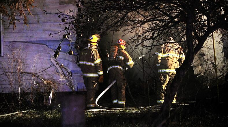 One person is dead after a car crashed into a house and both caught fire Wednesday evening, Dec. 8, 2021, in the 9900 block of state Route 235 in Champaign County on the border with Logan County. MARSHALL GORBY/STAFF