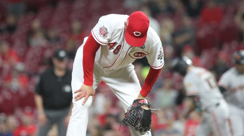 Jared Hughes reacts after giving up a go-ahead home run to Evan Longoria in the 11th inning on Friday, May 3, 2019, at Great American Ball Park in Cincinnati. David Jablonski/Staff