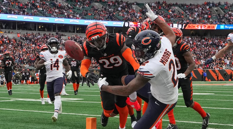 Chicago Bears wide receiver DJ Moore (2) crosses the goal line for a touchdown before dropping the ball during the first half of an NFL football game against the Cincinnati Bengals, Sunday, Nov. 2, 2025, in Cincinnati. (AP Photo/Jeff Dean)