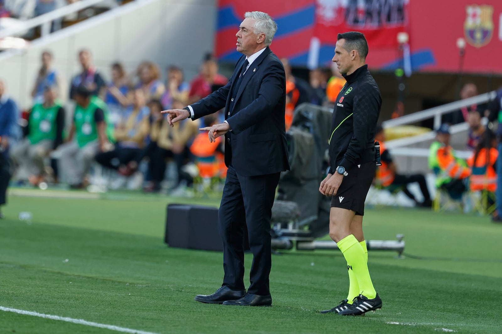 Real Madrid's head coach Carlo Ancelotti gives instructions during the La Liga soccer match between Barcelona and Real Madrid in Barcelona, Spain, Sunday, May 11, 2025. AP Photo/Joan Monfort)