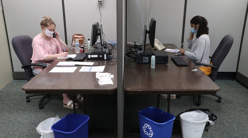 Lexee Trainer, left, and Lena Syed conduct contact tracing Thursday at the Clark County Combined Health District. BILL LACKEY/STAFF