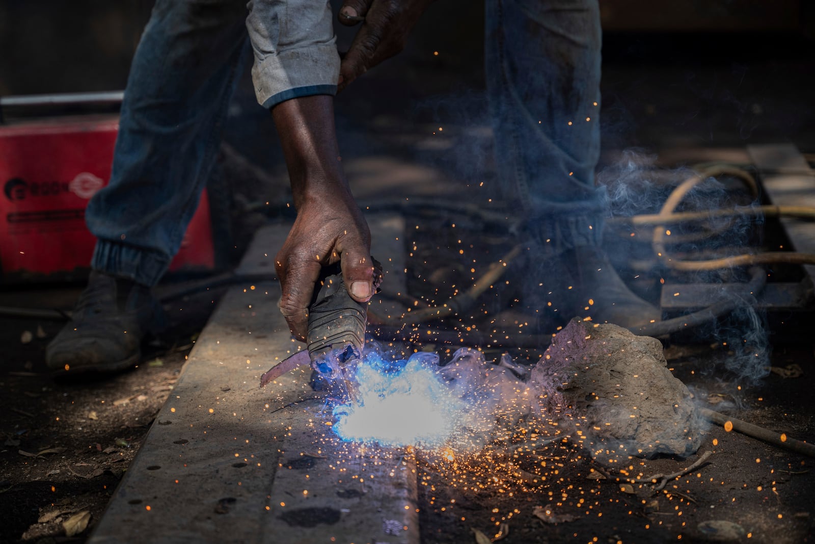 Mahamudu Bitego, a welder, whose business is powered in part by solar energy, works in Goma, Congo, May 23, 2025. (AP Photo/Moses Sawasawa)