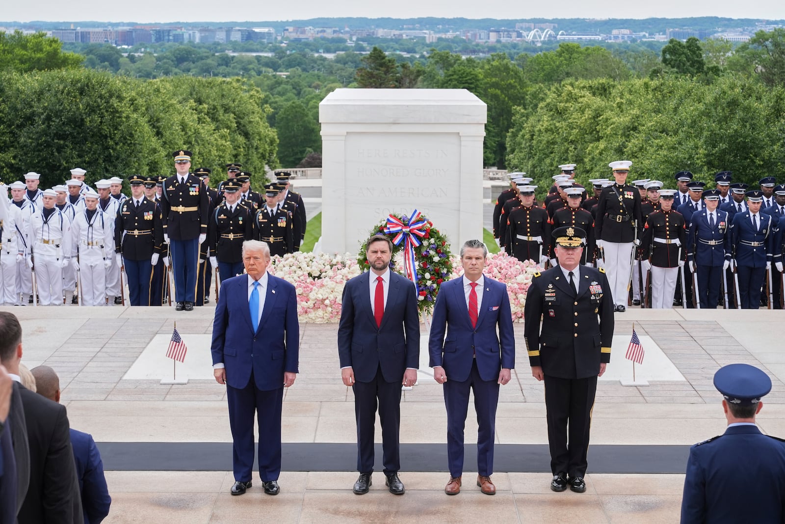 President Donald Trump, Vice President JD Vance, Secretary of Defense Pete Hegseth and Major General Trevor Bredenkamp, commanding general of the Joint Task Force-National Capital Region and the U.S. Army Military District of Washington, right, attend a Memorial Day wreath laying ceremony at Arlington National Cemetery, in Arlington, Va., Monday, May 26, 2025. (AP Photo/Jacquelyn Martin)