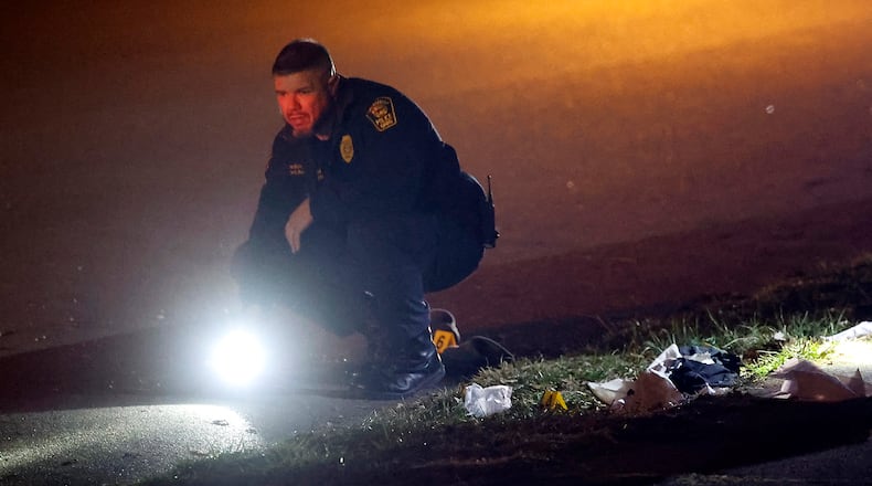 The Springfield Police Division investigates the scene of a shooting along the 600 block of Euclid Avenue Thursday evening, Dec. 21, 2023. According to police they arrived to find a male laying beside the road with a gunshot wound to the head. BILL LACKEY/STAFF