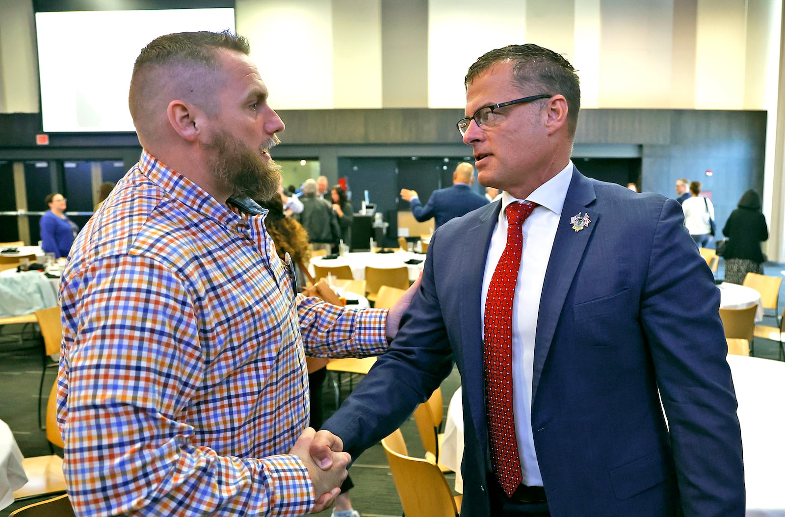 Former Clark County Prosecutor Andy Wilson, talks with Springfield City Manager Bryan Heck after talking about his new role as director of the Ohio Department of Public Safety Monday, April 10, 2023 during the Springfield Rotary Club's weekly meeting. BILL LACKEY/STAFF