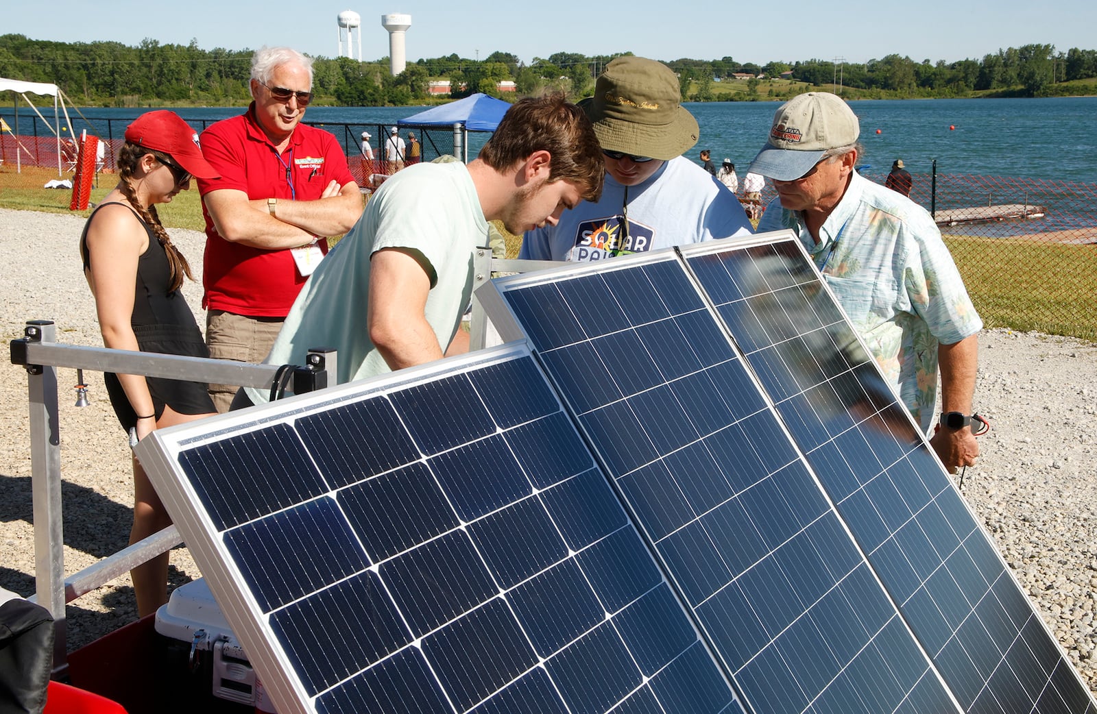 The team from the University of Southern Indiana works on their engine at the 2024 Solar Splash boat racing event.