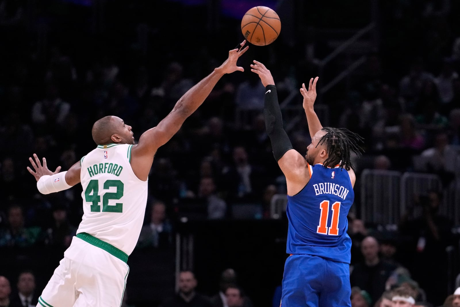 New York Knicks guard Jalen Brunson shoots a 3-point basket over Boston Celtics center Al Horford (42) during Game 1 of an NBA basketball second-round playoff series Monday, May 5, 2025, in Boston. (AP Photo/Charles Krupa)