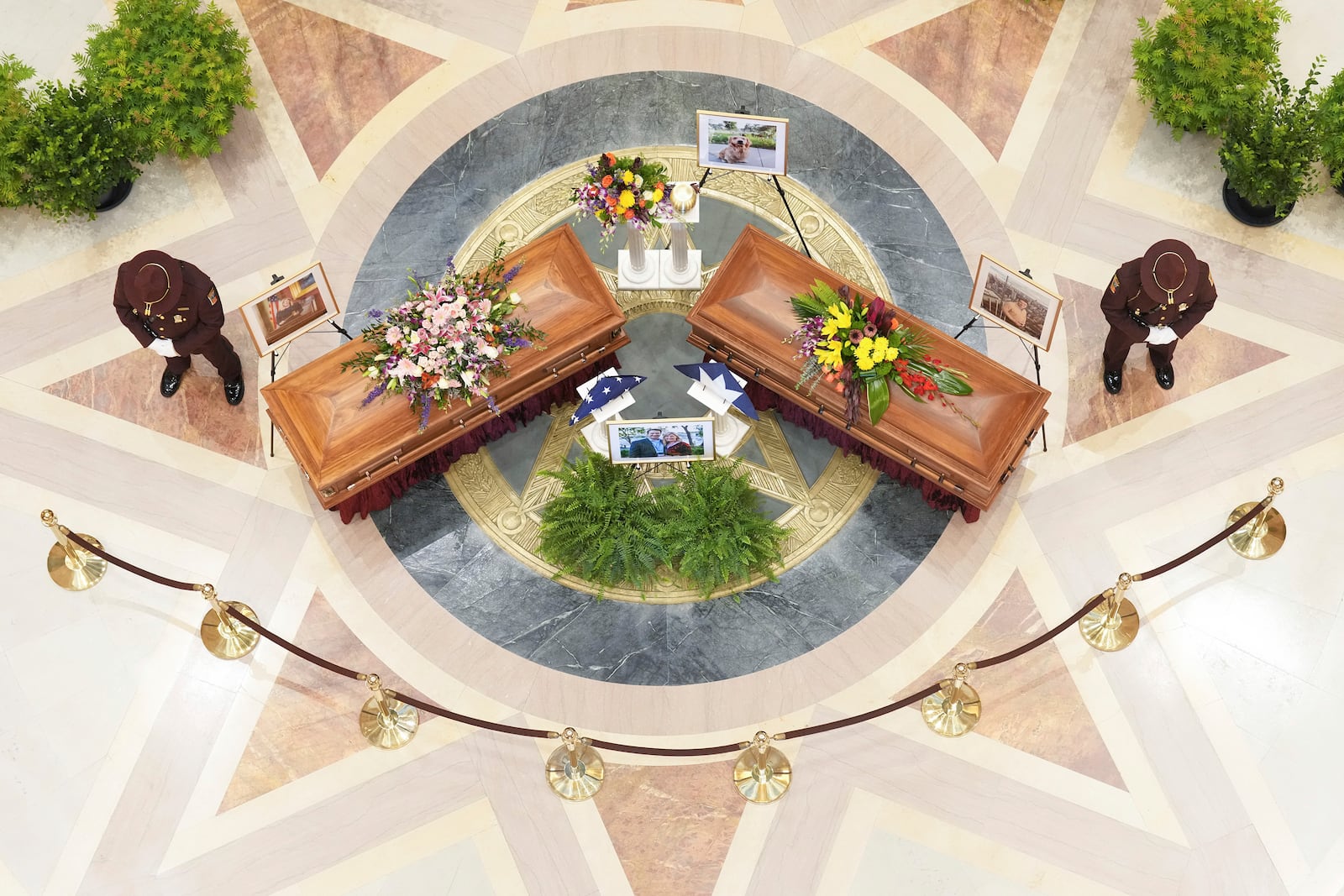 Minnesota State Representative Melissa Hortman, Mark Hortman and their dog, Gilbert, lie in state at the Minnesota State Capital in St. Paul, Minn., on Friday, June 27, 2025. (Alex Kormann/Star Tribune via AP)