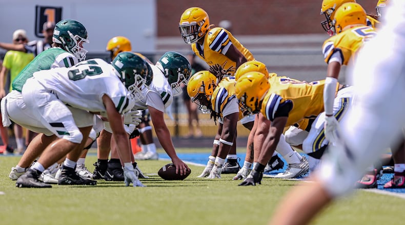 The Springfield High School defensive line awaits the snap during their game against Louisville Trinity earlier this month in Springfield. MICHAEL COOPER / STAFF