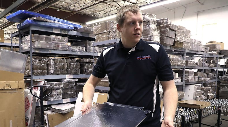 Jerad Miller, operations manager at New Method Packaging, talks about one of the packaging products they produce Tuesday, March 20, 2018. Bill Lackey/Staff