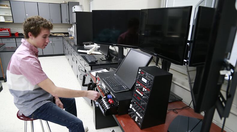 Nevin Hurst, 16, talks about the flight simulator in a classroom at Graham High School Tuesday. Bill Lackey/Staff