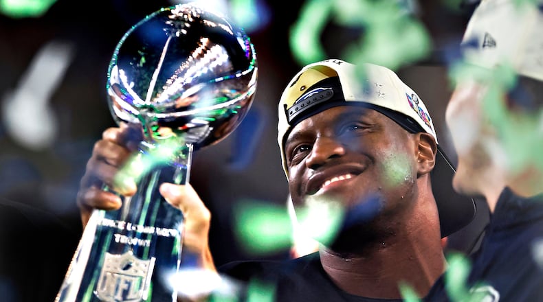 Seattle Seahawks running back Kenneth Walker III holds the Lombardi trophy after the Seahawks defeated the New England Patriots in the Super Bowl 60 in Santa Clara, Calif., Sunday, Feb. 8, 2026. (Scott Strazzante/San Francisco Chronicle via AP)