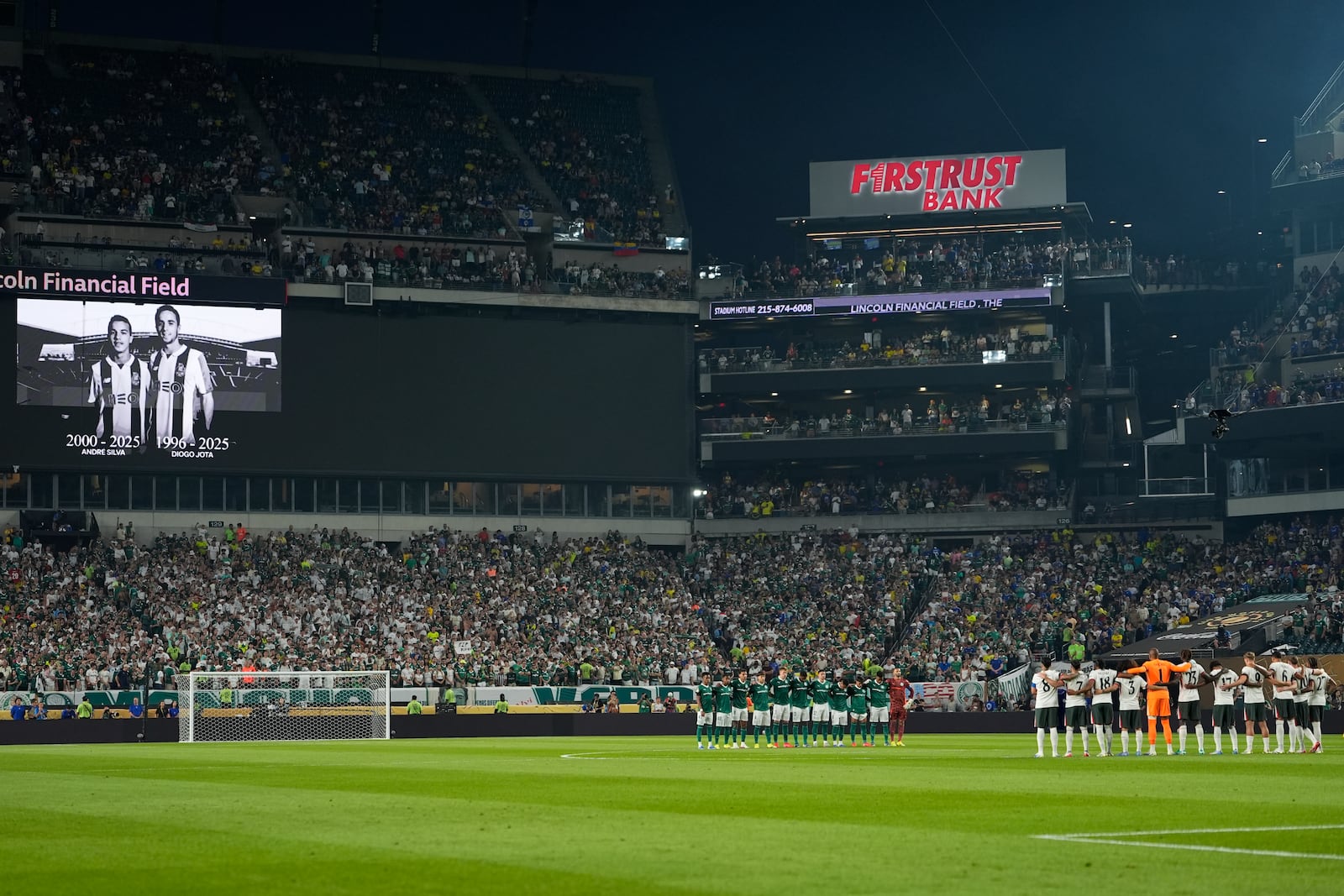 Chelsea and Palmeiras players observe a minute of silent in memory of Portugal international and Liverpool player Diogo Jota and his brother Andre Silva, prior to the Club World Cup quarterfinal soccer match between Palmeiras and Chelsea in Philadelphia, Friday, July 4, 2025. (AP Photo/Chris Szagola)