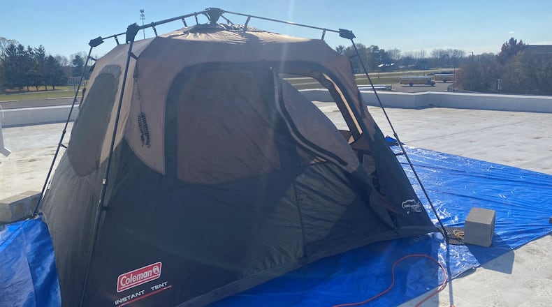 Tecumseh Local Schools Superintendent Paula Crew, along with high school guidance counselor Suzanne Massie and a paraprofessional Jennifer Lewis, stayed the night Wednesday on the high school roof after students raised over $1,000 for breast cancer awareness. Contributed