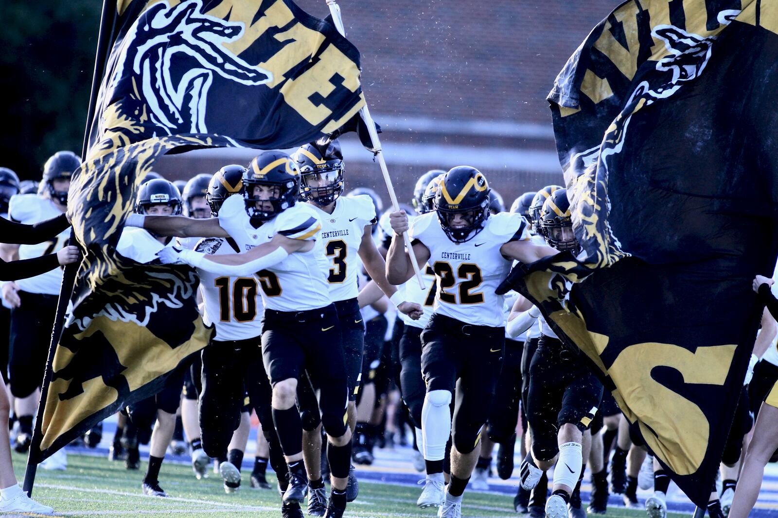 Centerville players run onto the field before a game against Gahanna Lincoln on Friday, Sept. 3, 2021, at Gahanna. David Jablonski/Staff