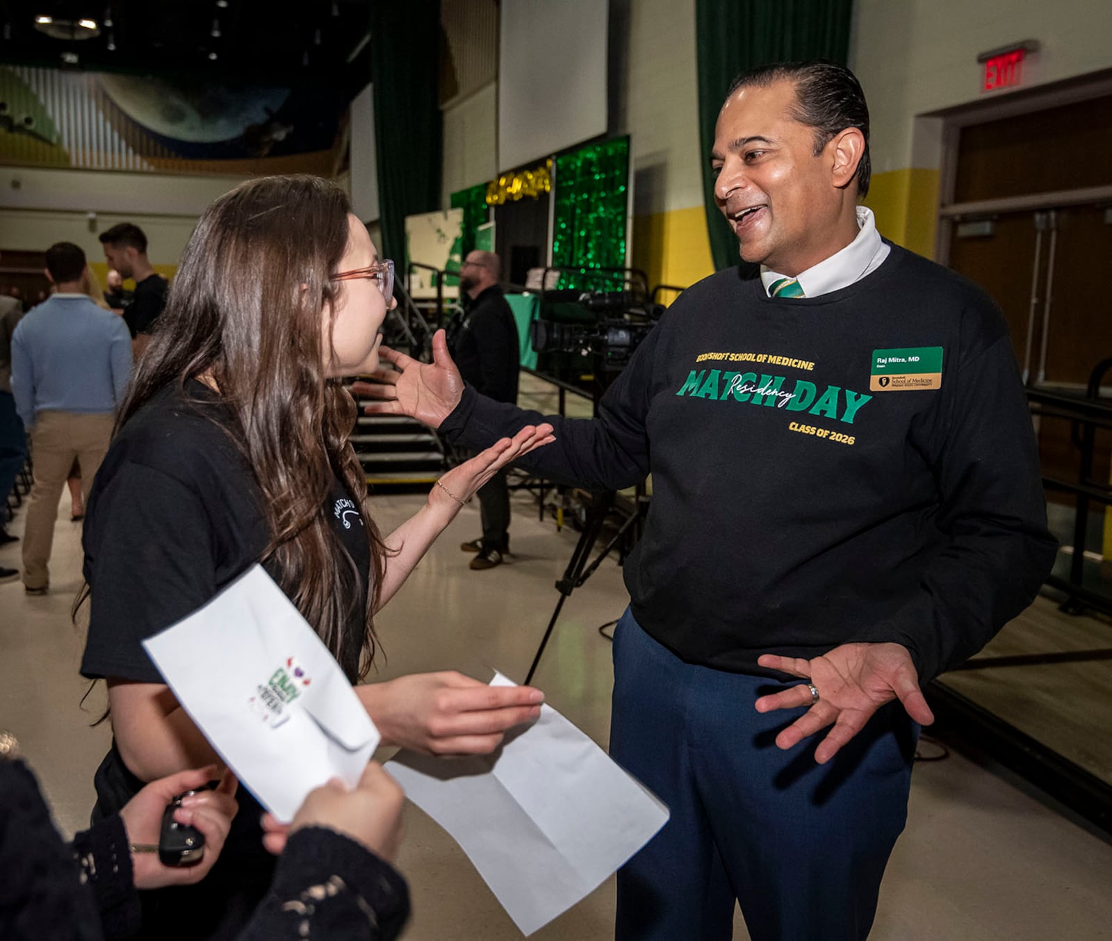 Dr. Raj Mitra, dean of the Boonshoft School of Medicine and chief academic officer at Premier Health, talks to medical student Francesca Savona from the Wright State University Boonshoft School of Medicine after Savona learned her residency placement for her postgraduate training on March 20, 2026. COURTESY OF WRIGHT STATE UNIVERSITY
