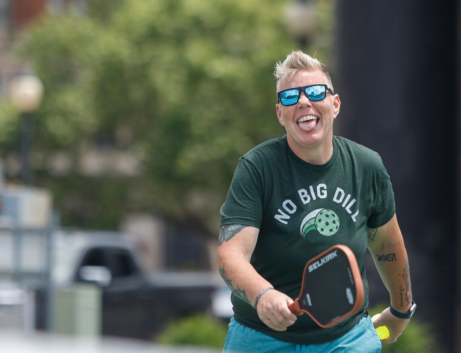 Denise Jones celebrates after her team wins a pickleball game on Thursday, May 29, 2025, at City Hall Plaza. JOSEPH COOKE/STAFF