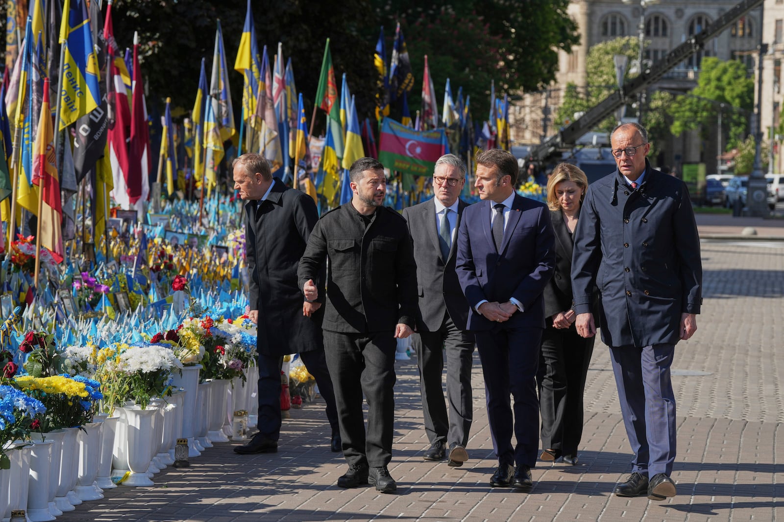 From left, Polish Prime Minister Donald Tusk, Ukrainian President Volodymyr Zelenskyy, U.K. Prime Minister Keir Starmer, French President Emmanuel Macron, German Chancellor Friedrich Merz arrive to put flowers on memorial of fallen Ukrainian soldiers at independence square during a ceremony for 80th anniversary of VE Day in a memorial park in Kyiv, Ukraine, on Saturday, May 10, 2025. Ukraine's First Lady Olena Zelenska Olena Zelenska is seen behind, second right. (AP Photo/Evgeniy Maloletka)