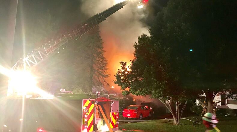 Flames light the early morning sky from on house fire on Dover Road in Springfield Thursday morning. DEANGELO BYRD/STAFF