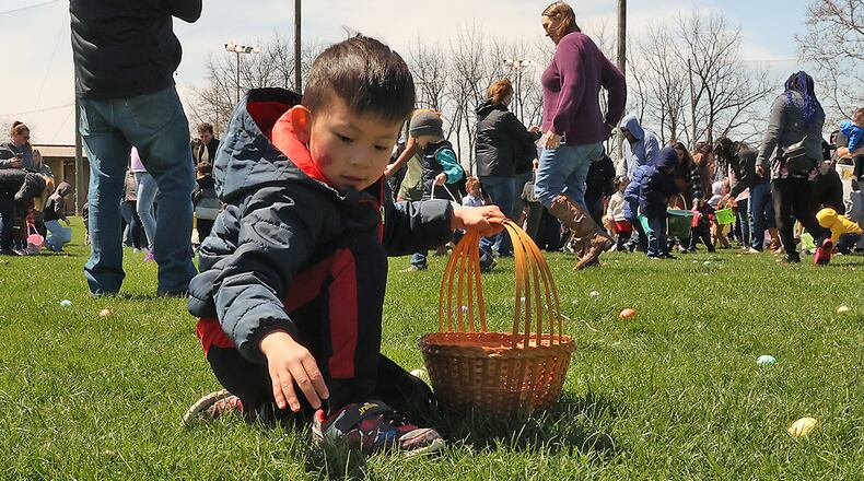 Hundreds of children race across the driving range at Young's Jersey Dairy picking up dyed hard boiled eggs during the annual Easter Egg Hunt Sunday, April 17, 2022. This was the 39th anniversary for the egg hunt at the dairy, however, it was the first time in two years it was held due to the COVID pandemic. This year Young's put out over 10,000 eggs for the children to collect. BILL LACKEY/STAFF