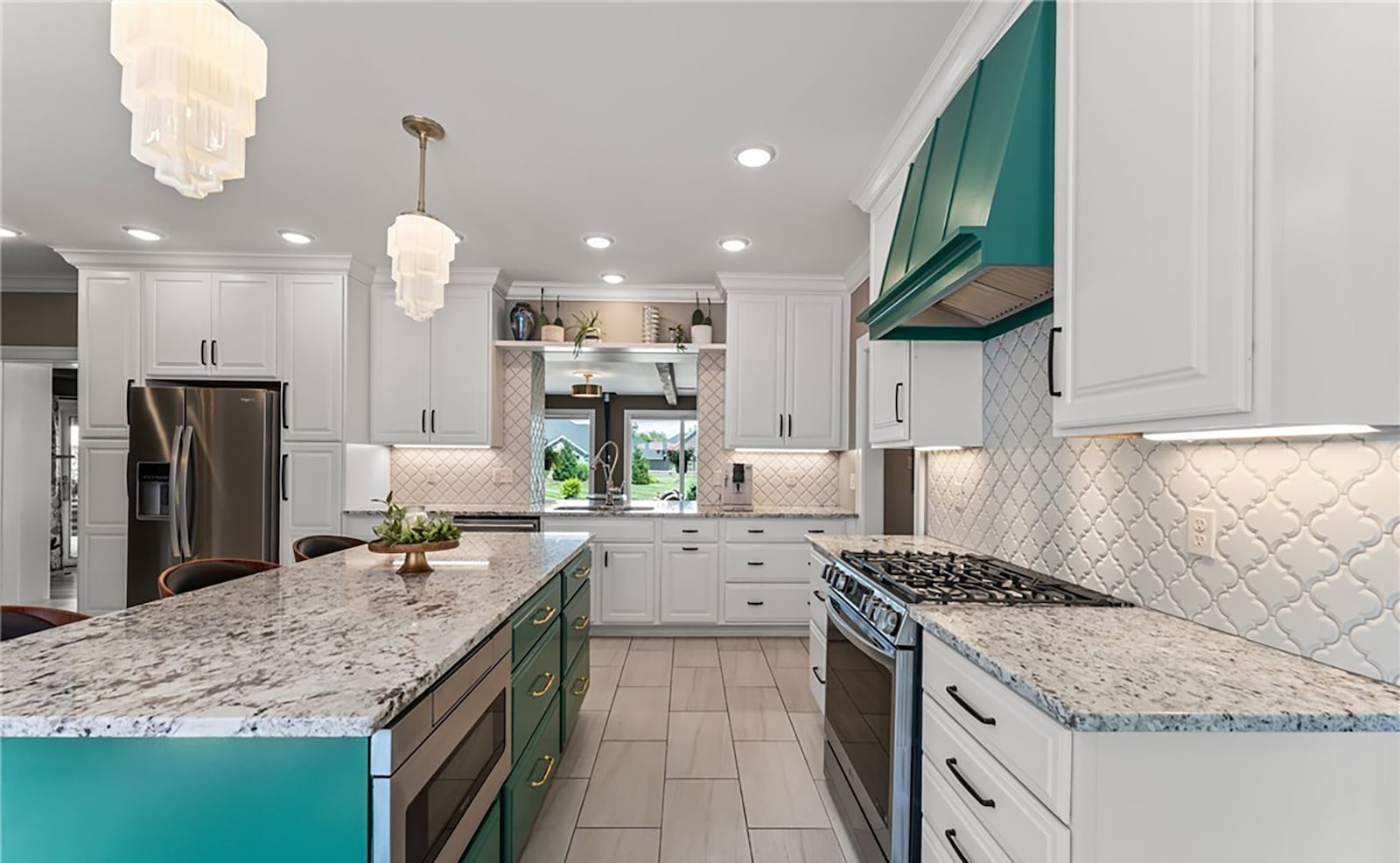 The completely renovated kitchen has tile flooring, white cabinets, a kitchen island with bar seating, recessed lighting and decorative chandeliers and tile backsplash. All new appliances include a gas range, drawer style microwave, side by side refrigerator,  and dishwasher. There is also a breakfast nook. CONTRIBUTED