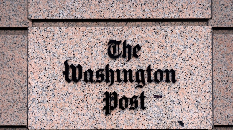 A sign for the Washington Post is seen at the company's offices, Monday, Jan. 26, 2026, in Washington. (AP Photo/Mark Schiefelbein)