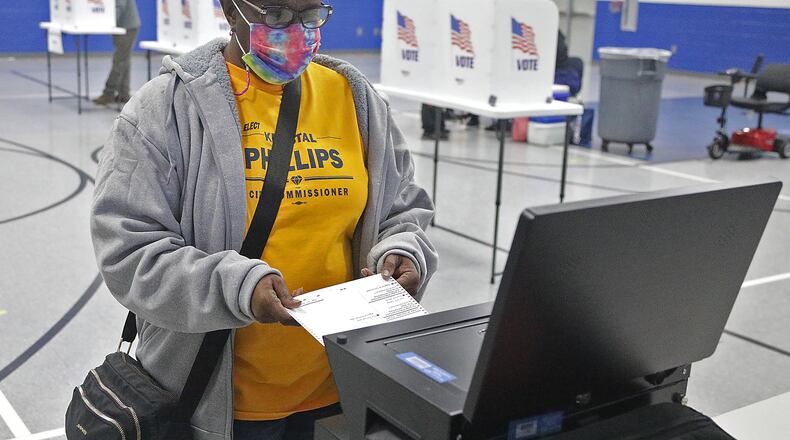 Diantha Applin places her ballot in the voting machine at Fulton Elementary Tuesday. BILL LACKEY/STAFF