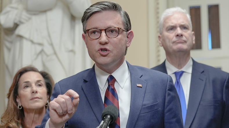 Speaker of the House Mike Johnson, R-La., center, speaks while House Majority Whip Tom Emmer R-Minn., right, and House Republican Conference Chair Lisa McClain, R-Mich., left, listen during a news conference on Capitol Hill, Friday, March 27, 2026, in Washington. (AP Photo/Mariam Zuhaib)