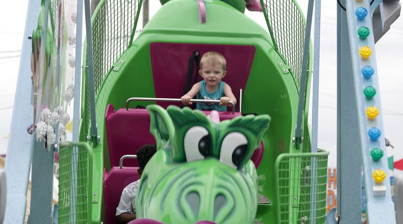 Emerson Leigh, 4, sits in the back of a swing ride at the Clark County Fair Tuesday, July 26, 2022. BILL LACKEY/STAFF