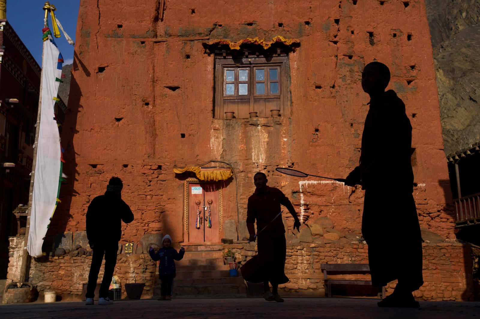 Monks play badminton in front of a monastery at Kagbeni, Mustang region, 462 kilometers (288 miles) west of Kathmandu, Nepal, Thursday, April 17, 2025. (AP Photo/Niranjan Shrestha)