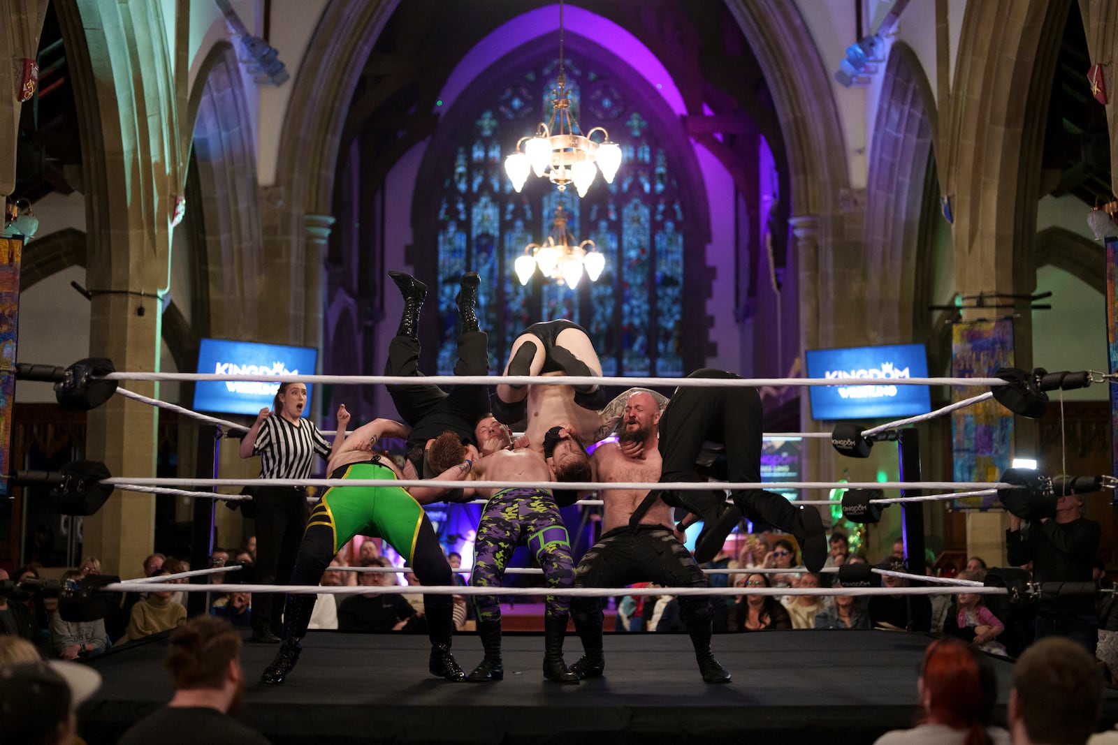 A six-man-scramble plays out in the ring at a Kingdom Wrestling show at St Peter's Church in Shipley, Saturday, March 29, 2025. (AP Photo/Jon Super)