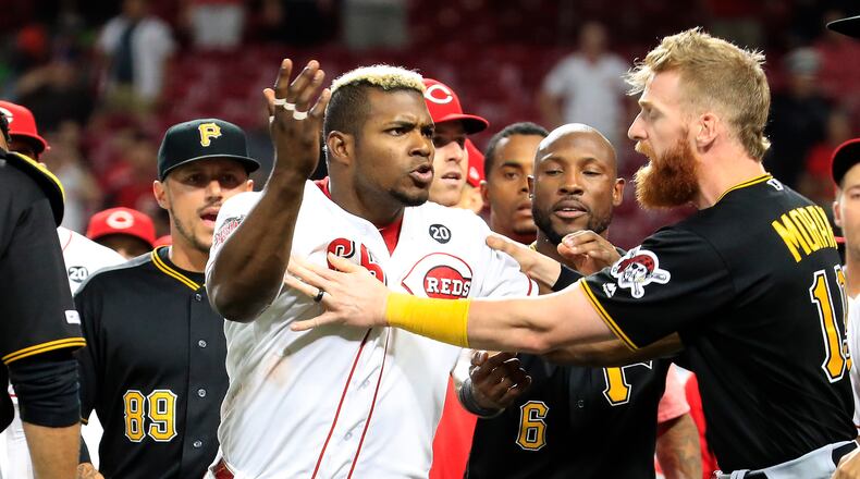 CINCINNATI, OHIO - JULY 30: Yasiel Puig #66 of the Cincinnati Reds is restrained during a bench clearing altercation in the 9th inning of the game against the Pittsburgh Pirates at Great American Ball Park on July 30, 2019 in Cincinnati, Ohio. (Photo by Andy Lyons/Getty Images) *** BESTPIX ***