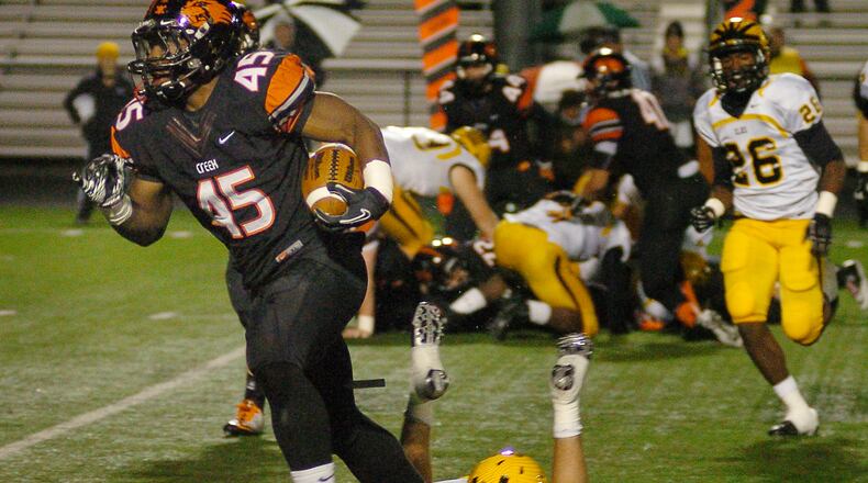 Beavercreek's linebacker Airius Moore rushes past Centerville's defense for the goal line at Frank Zink Field on Friday evening.