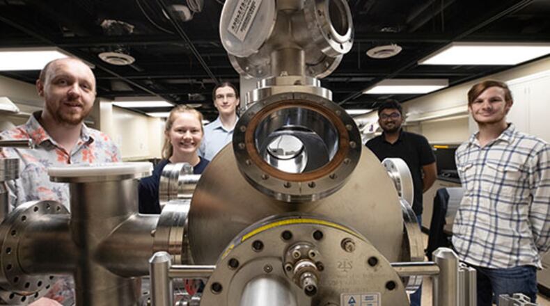 Perry Corbett, assistant professor of Physics, left, stands with students Sara McGinnis, Carter Wade, Lakshan Don Manuwelge Don and Nate Price around the newly donated ultra-high vacuum scanning tunneling microscope. PHOTO: JEFF SABO/CONTRIBUTED