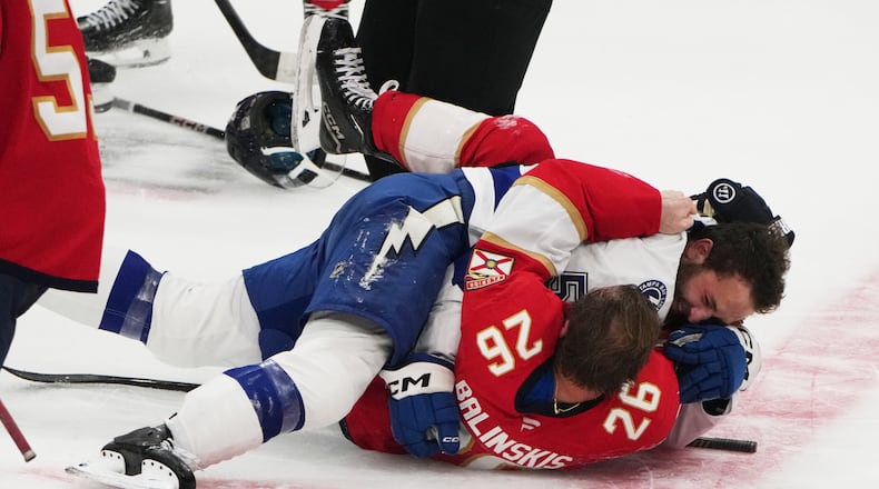 FILE - Florida Panthers defenseman Uvis Balinskis (26) and Tampa Bay Lightning Dylan Duke, right, scuffle during the third period of a preseason NHL hockey game, Saturday, Oct. 4, 2025, in Sunrise, Fla. (AP Photo/Lynne Sladky, File)