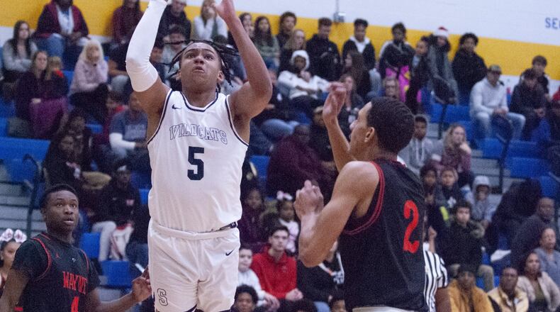 Springfield’s Josh Tolliver shoots past the defense of Wayne’s Brendan Hill during the first half of Friday night’s game at Springfield. Jeff Gilbert/CONTRIBUTED