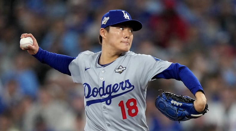 Los Angeles Dodgers pitcher Yoshinobu Yamamoto (18) delivers during the sixth inning in Game 2 of baseball's World Series against the Toronto Blue Jays, Saturday, Oct. 25, 2025, in Toronto. (Nathan Denette/The Canadian Press via AP)