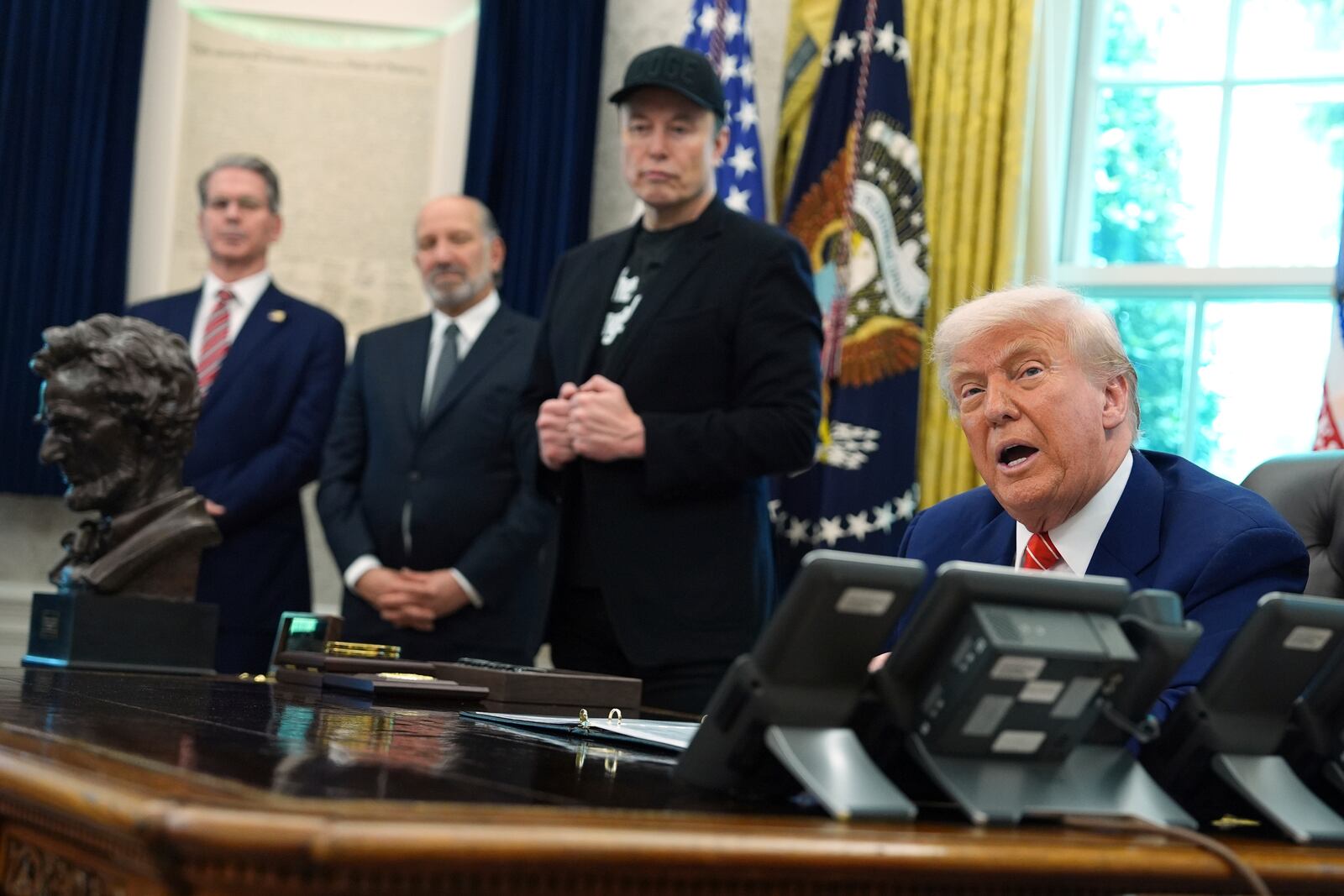 President Donald Trump, from right, speaks during a news conference with Elon Musk as Commerce Secretary Howard Lutnick and Treasury Secretary Scott Bessent listen in the Oval Office of the White House, Friday, May 30, 2025, in Washington. (AP Photo/Evan Vucci)