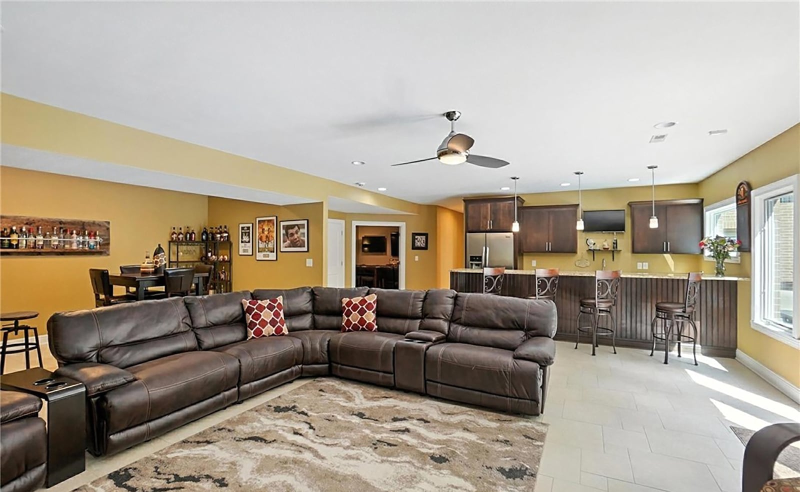 The finished walk out basement has a recreation room with fireplace and kitchenette that walks out to the inground pool and patio.