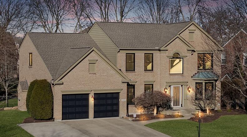 This brick two story sits on a .29 acre wooded lot in Springboro.