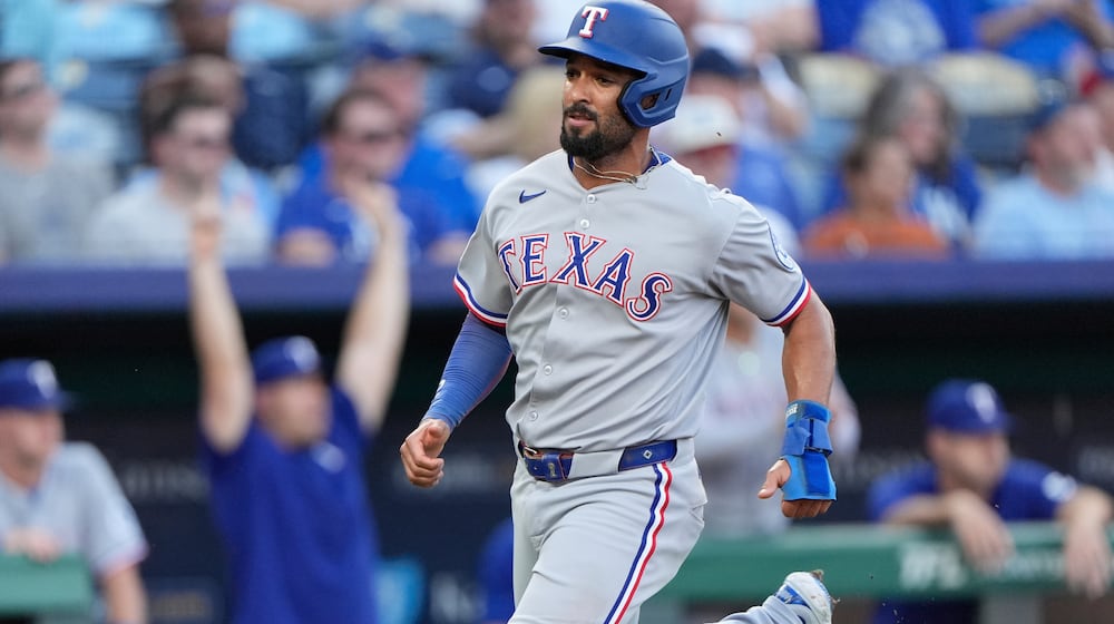 FILE - Texas Rangers' Marcus Semien runs home to score on an RBI single hit by Jonah Heim during the second inning of a baseball game against the Kansas City Royals, Monday, Aug. 18, 2025, in Kansas City, Mo. (AP Photo/Charlie Riedel, File)
