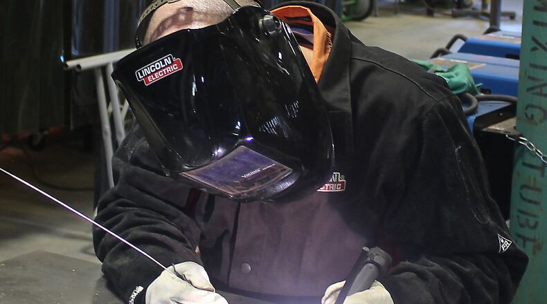 Clark State Community College welding instructor, Jonathan Pack demonstrates a welding process. JEFF GUERINI/STAFF