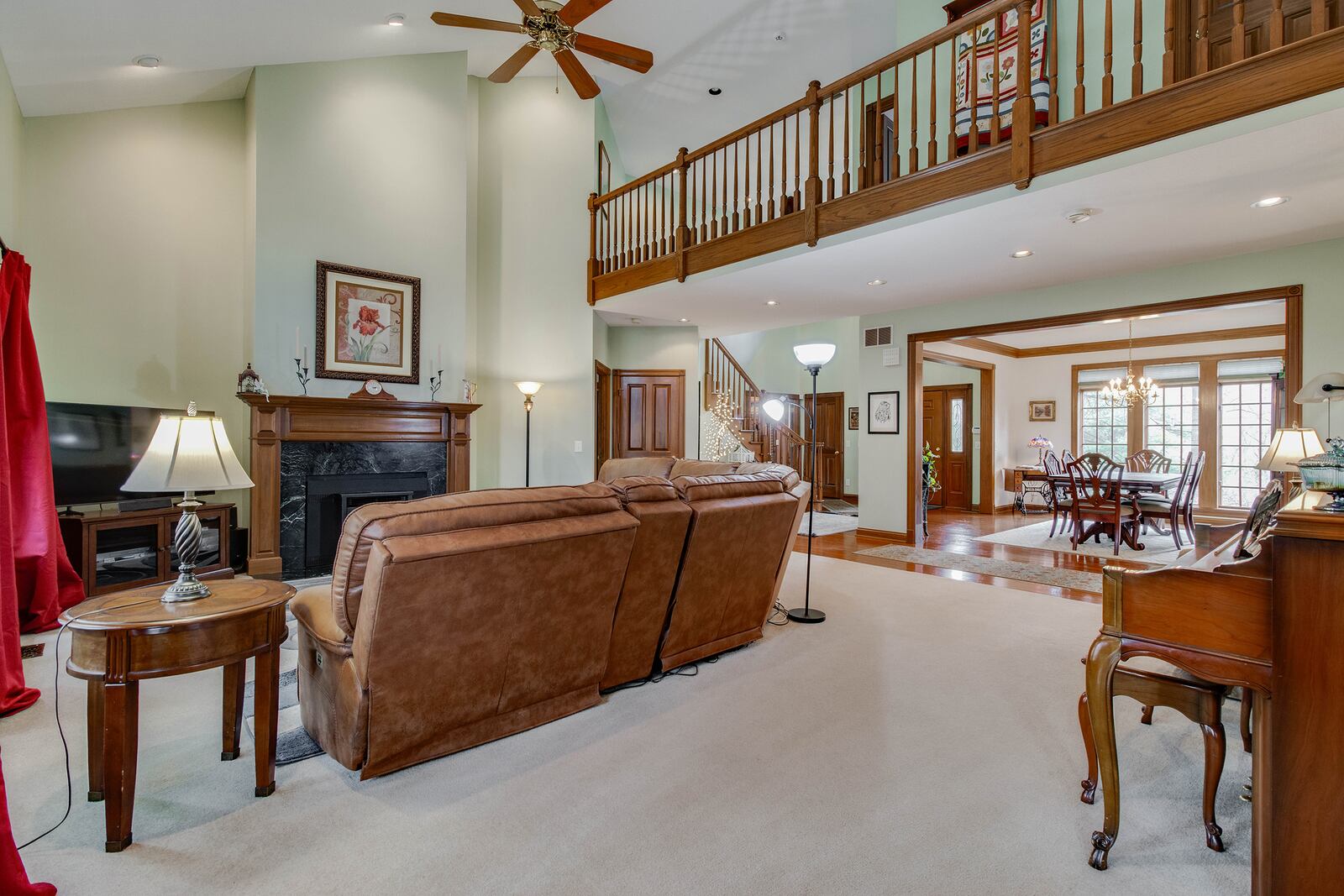 The family room has a woodburning fireplace with stove insert, vaulted ceiling and neutral carpeting.