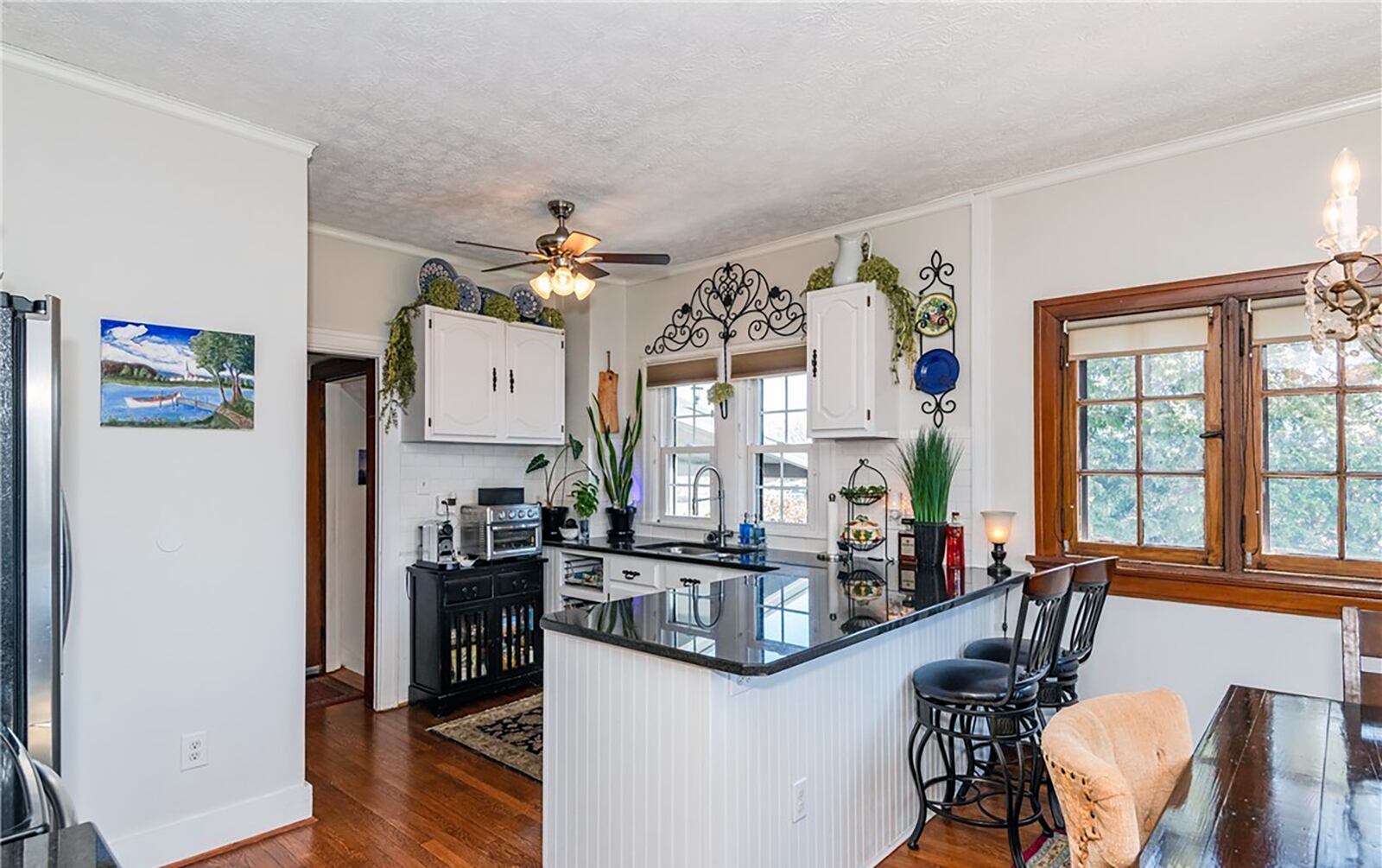 The kitchen has been updated with stainless appliances and has hardwood flooring and an eat in dining area.