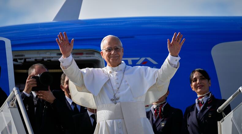 Pope Leo XIV waves as he boards a flight back to the Vatican after his visit to Lebanon at Beirut International Airport in Beirut, Lebanon, Tuesday, Dec. 2, 2025. (AP Photo/Hussein Malla)