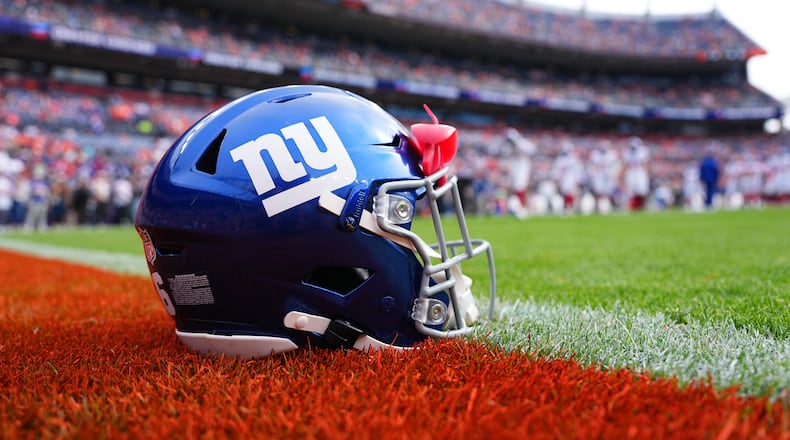FILE - A New York Giants helmet is shown on the field before an NFL football game between the Denver Broncos and the Giants in Denver on Oct. 19, 2025. (AP Photo/Jack Dempsey, File)